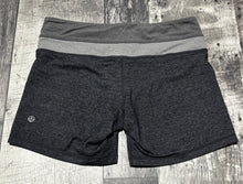 Load image into Gallery viewer, lululemon black/grey shorts - Hers size 6
